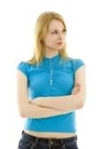Angry_face : standing angry or sad young woman in turquoise blouse  Stock Photo