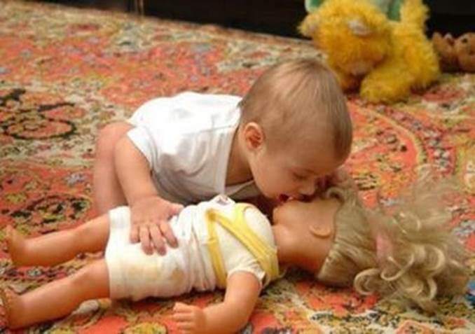 Funny. Kids Kissing Doll