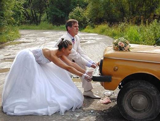 http://myworkbreak.com/funny_wedding_pictures/funny_weddings_photos_struggeling_pull_car_out_europe.jpg