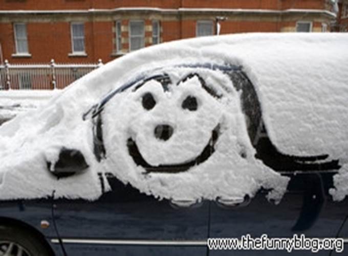 smiley-artwork-on-parked-car-snow