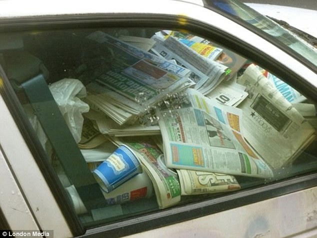 Well-read: Newspapers are piled high in this vehicle along with empty drinks containers and other packets