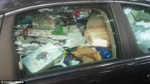 Nowhere to sit: A box of facial tissues is among the debris inside this car, which is packed with rubbish