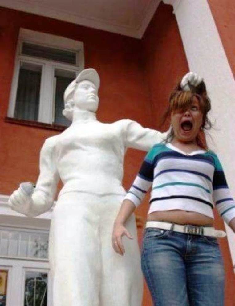 People posing with statues