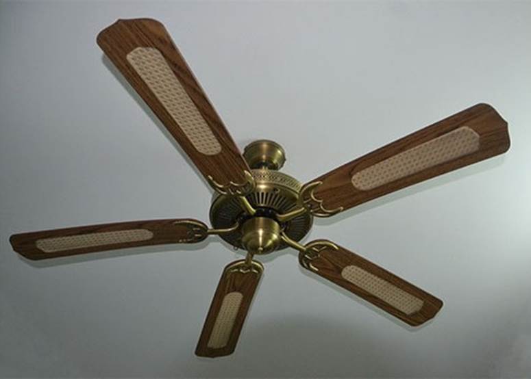 Ceiling fans have a switch for winter mode where the blades spin backwards slowly. This causes the trapped warm air near the ceiling to flow back down to the floor by way of the walls.